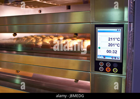 LCD screen of oven with bread in the bakery Stock Photo
