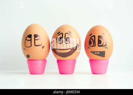 Cheerful eggs three friends, brown eggs. Photo for design. Eggs with painted face. Horizontal orientation of the sheet. Stock Photo