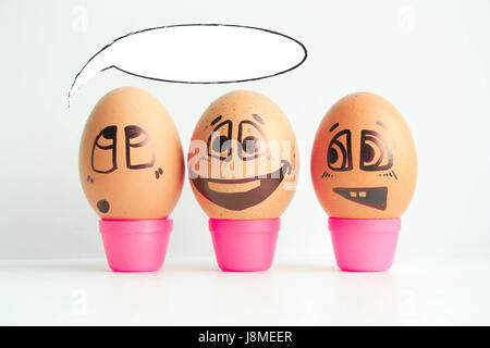 Cheerful eggs three friends, brown eggs. Thinking out loud. Place under the text. Photo for design. Eggs with painted face. Horizontal orientation of  Stock Photo