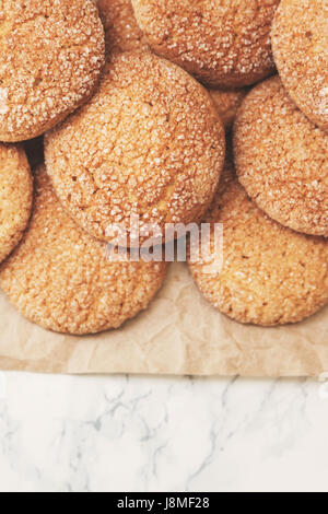 On a marble white table, sandy round cookies, one broken, top view, close-up. Empty place for records. In retro, old style. Stock Photo