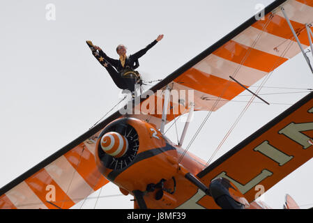 Breitling Wingwalkers displaying at an air show with girls on the top wing of vintage Boeing Stearman biplanes Stock Photo