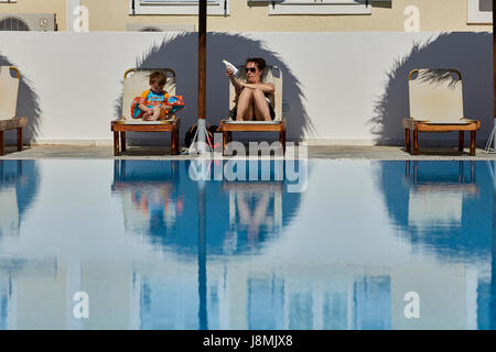 Volcanic Greek island Santorini one of the Cyclades islands in the Aegean Sea.  family fun Kamari Alexandra Hotel Stock Photo