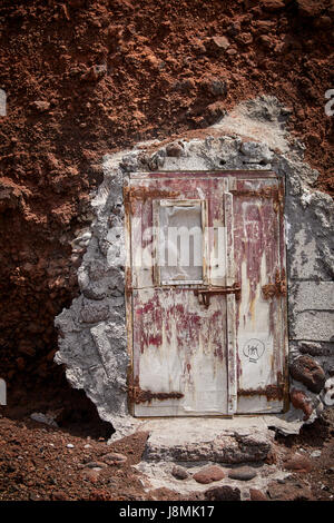 Volcanic Greek island Santorini one of the Cyclades islands in the Aegean Sea. Red Beach and rocks doorway Stock Photo