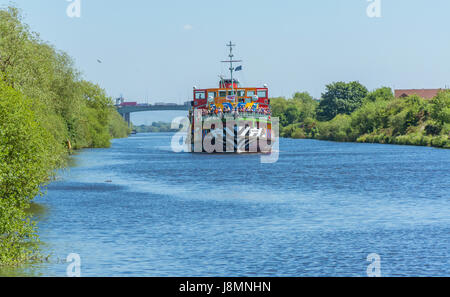A view of the pleasure cruiser 'Snowdrop' sailing along the Manchester Ship Canal on approach to Latchford Locks in Warrington. Stock Photo