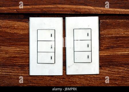 Photo of light switches on a concrete wall Stock Photo