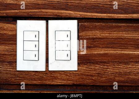 Photo of light switches on a concrete wall Stock Photo