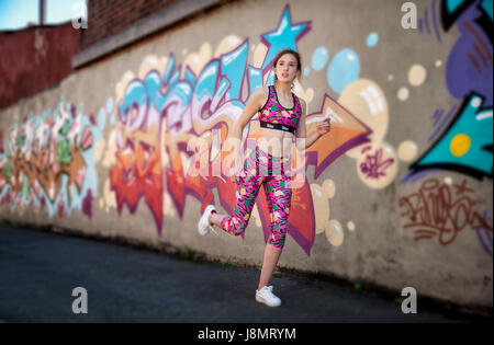 woman wearing colourful sportswear in the street Stock Photo