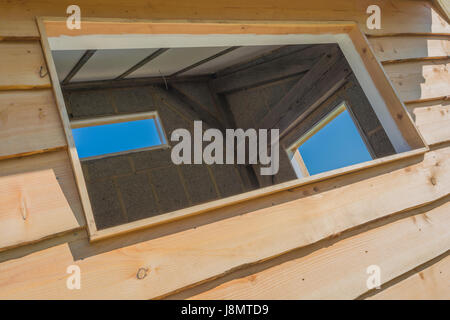 Three empty windows spaces in an outside office shed / building. Stock Photo