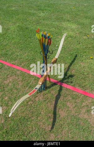Sports target bow and arrows at the standing line on an archery range. Stock Photo