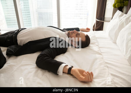 Businessman resting at home after hard day at work Stock Photo