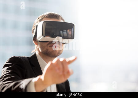 Man in VR headset using gestures in simulation Stock Photo