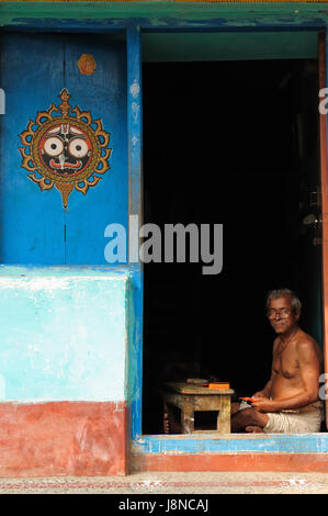 PURI, INDIA -  18 DECEMBER 2009: Soothsayer sitting in the door of his house waiting for pilgrims in order to tell them fortune Stock Photo