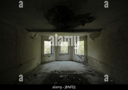 Three windows in an old and ruined building. Stock Photo