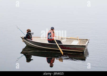 Father and son in a tin boat fishing on a Canadian lake Stock Photo