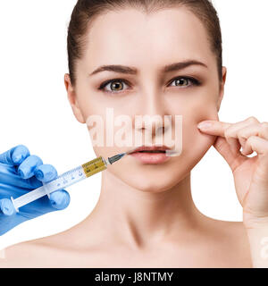 Beautiful woman gets injection in her lips. Isolated over white background. Plastic surgery and beauty concept. Stock Photo