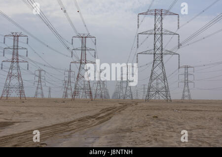 Large power lines through the desert providing the high demand for electricity in Kuwait City. Stock Photo