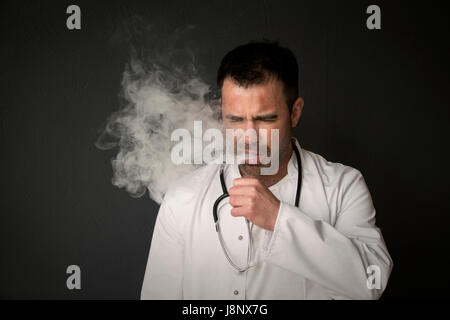 portrait of handsome doctor smoking and coughing Stock Photo