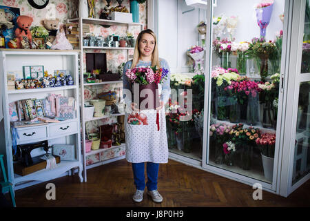 woman florist holding bouquet of hyacinth indoor in flower shop Stock Photo
