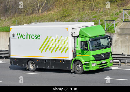 Mercedes lorry truck supply chain transportation logistics providing food distribution delivery to Waitrose stores driving along English UK motorway Stock Photo