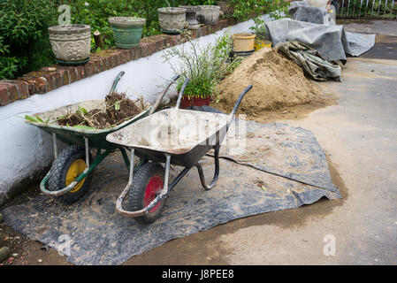 Two builders wheelbarrows stored neatly at the end of the day on site Stock Photo