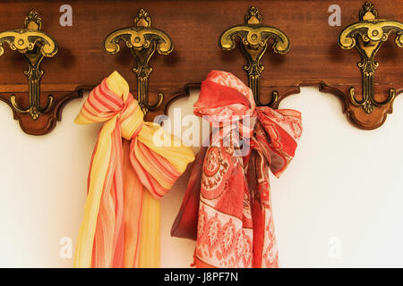 Colored scarves on antique hanger Stock Photo