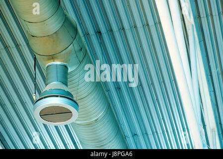 Industrial ventilation system pipes on warehouse ceiling Stock Photo