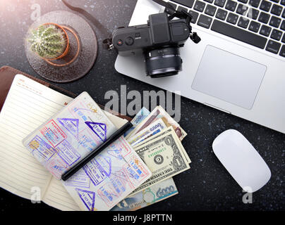 Tourism plan desktop with passport and money for tour in asia photo with studio lighting. Stock Photo