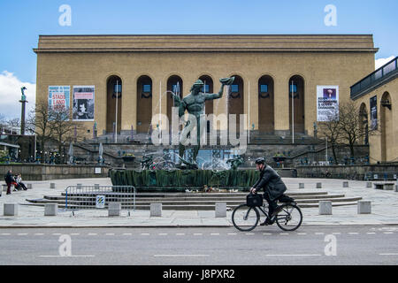 GOTHENBURG, SWEDEN - MAY, 2017: Cyclist riding a bike in front of Poseidon Fountain in Gothenburg, Sweden. Stock Photo
