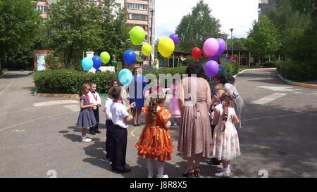 Kursk, Russia - May 26, 2017: Balloons in the sky.Kindergarten celebrates its anniversary. Children took to the streets with a beautiful balloon. After congratulations - all the guests and children released balloons into the sky