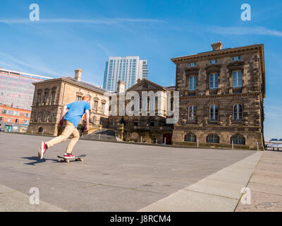 Young man skateboarding in Custom House Square, Belfast. The Custom House is in the background Stock Photo