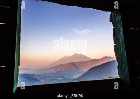 Dawn over two volcanoes: Fuego & Acatenango, near Antigua, Guatemala, Central America Stock Photo