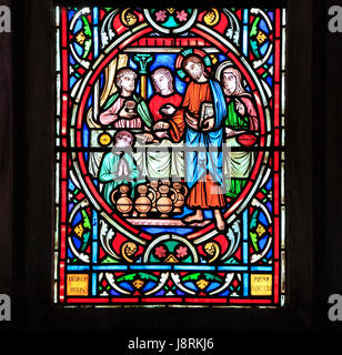 Scene from Life of Jesus, by Adolph Didron, Paris, 1860, stained glass window, Feltwell, Norfolk. Jesus at Cana Wedding Feast, turns water into wine.  Stock Photo