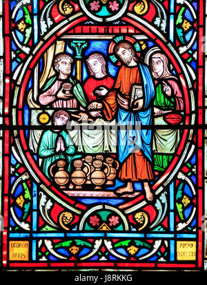 Scene from Life of Jesus, by Adolph Didron, Paris, 1860, stained glass window, Feltwell, Norfolk. Jesus at Cana Wedding Feast, turns water into wine.  Stock Photo