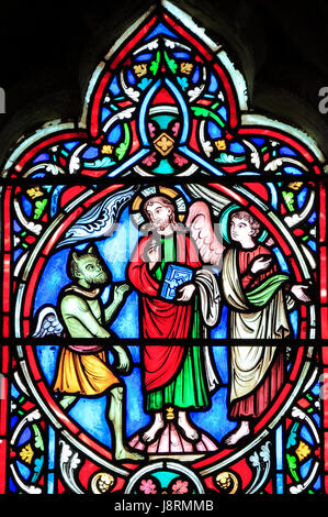 Scene from Life of Jesus, by Adolph Didron, Paris, 1860, stained glass window, Feltwell, Norfolk, England.. Jesus tempted by Satan, in Judaean Desert  Stock Photo