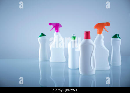 Spring cleanup theme. Variety of  house cleaning products on white table and background. Stock Photo