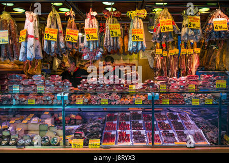 Barcelona, Spain - 18 September 2013 - One of many meat and cheese counters offering variety of products at famous La Boqueria Market in Barcelona. Stock Photo