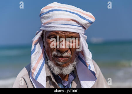 Portrait of a Sri Lankan fisherman working with a team of fishermen to pull in a catch on Uppuveli Beach outside of Trincomalee in Sri Lanka Stock Photo