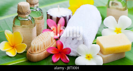 Spa, wellness setting with flowers on a palm leaf Stock Photo