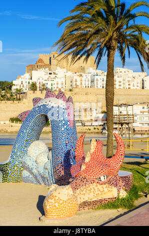 Colourful mosaic dragon, a mini playground on the beach along the waterfront promenade of Playa Norte, Peniscola, Spain Stock Photo