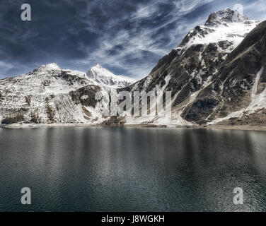 Alpine lake in the Formazza valley with blue sky and clouds in a spring sunny day, Piedmont - Italy Stock Photo