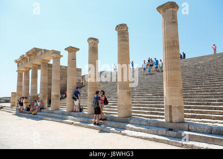 LINDOS, RHODES ISLAND, GREECE - September 3, 2015:   Tourists and visitors exploring  the colonnade of Grand Hellenistic Portico of the ancient Acropo Stock Photo