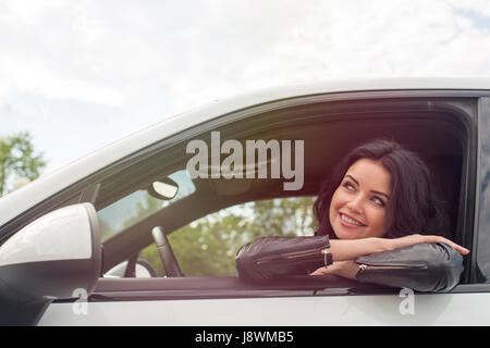 Young Woman Sitting Inside Car Smiling Stock Photo