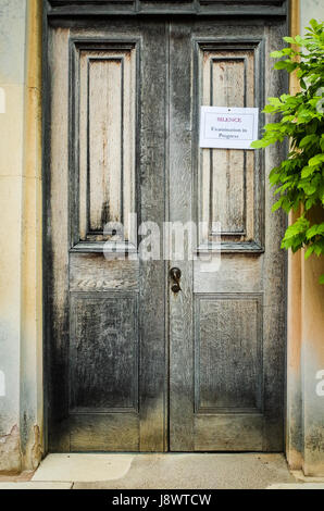 "Silence Examination in Progress" sign on a college door in Downing College, part of the University of Cambridge, UK Stock Photo
