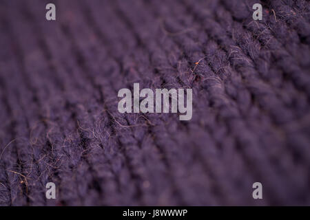 Texture of dark blue knitted woolen fabric closeup Stock Photo