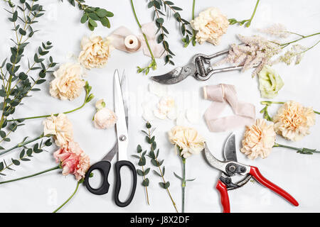 The florist desktop with working tools on white wooden background Stock Photo