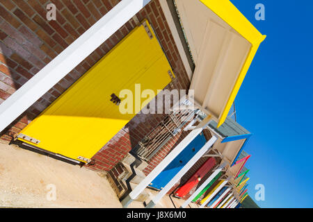 Row of colourful beach huts at Swanage in May - angled for dynamic impact Stock Photo