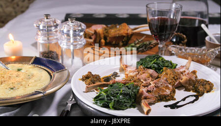 View of a rack of lamb with crusted mint sauce and mashed potatoes Stock Photo