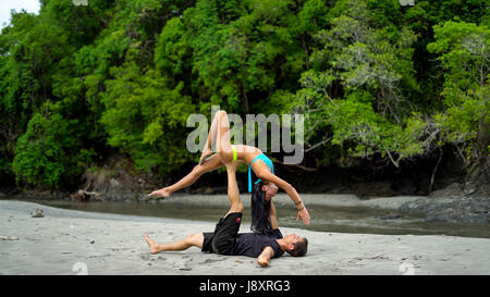 STUNNING photographs and video have revealed one couple’s incredible bond as they combine their passions for yoga and free running. The incredible pictures show the husband and wife team balancing on each other to pull some impressive shapes on the beach and in the park whilst video footage show the pair mastering a romantic backbend kiss. Other gravity defying shots show Amor Armitage balancing on a piece of driftwood whilst her husband, Chase performs an impressive flip through the air. @chaseyamor / mediadrumworld.com Stock Photo