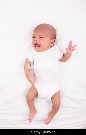 Mixed race south asian and caucasian newborn baby on white sheet Stock Photo