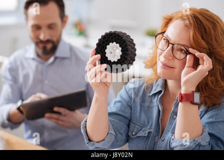 Smart creative woman fixing her glasses Stock Photo